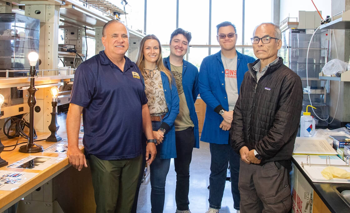 Group of UCSB faculty standing in workshop setting